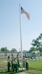 Boy Scouts raise the flag at the dedication ceremony